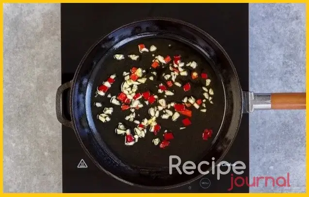 На сковороде разогреваем растительное масло (в оригинале оливковое), томим несколько минут измельченные перец и чеснок. Перец отдает остроту, а чеснок аромат, можно потом их убрать со сковороды, но если они останутся, хуже не будет.