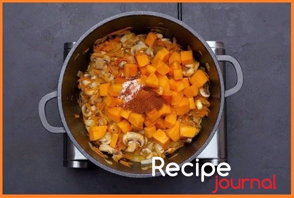 Добавляем на сковороду к овощам тыкву, солим и перчим по вкусу, вливаем бульон или воду, накрываем крышкой и тушим минут 15.